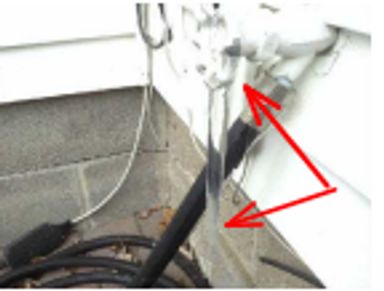 An outside faucet with an icicle hanging from it found during a home watch inspection.