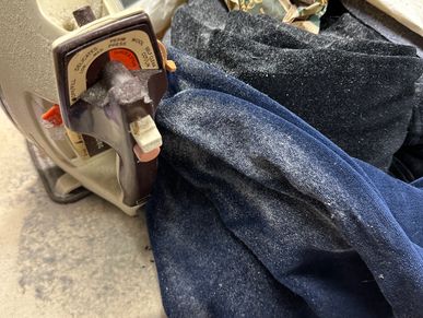 Mildew and Mold on clothing and ironing board found during a home watch inspection.