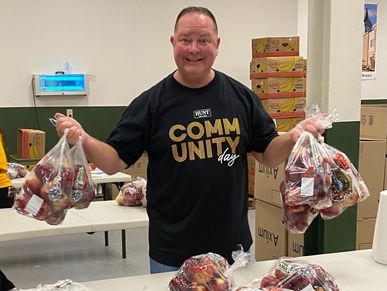 Dan Powell packing apples into bags that will eventually be sent to families in the Rochester, NY