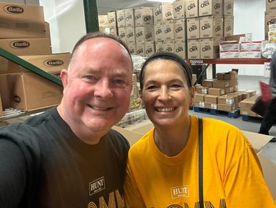 Dan Powell and another volunteer taking a selfie photo during a volunteering event at the Food Link