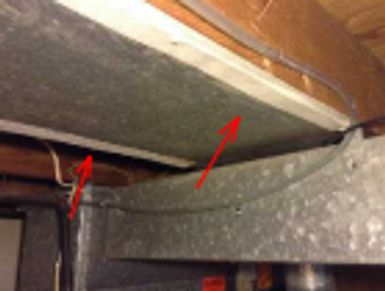 Asbestos duct tape on a furnace cold air return found during a home watch inspection.