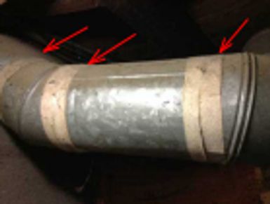 Asbestos duct tape on a furnace supply duct found during a home watch inspection.