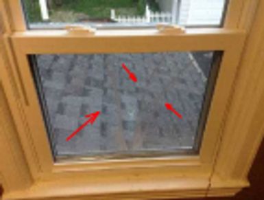 A broken window found during a home watch inspection.