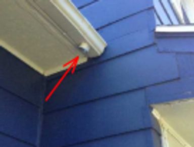 A gutter missing its downspout observed during an emergency home watch visit after a wind storm.