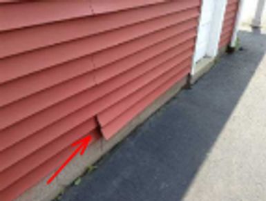 Loose vinyl signing found during an emergency home watch inspection.