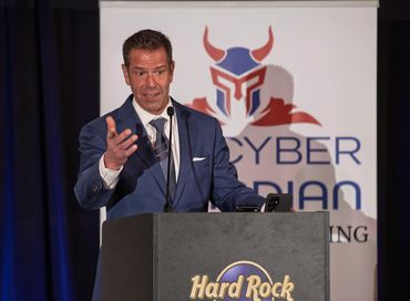 Man delivering a speech on stage in front of an audience