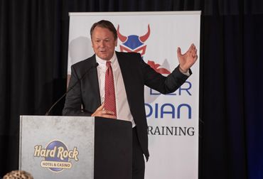 Presenter addressing a crowd from the stage