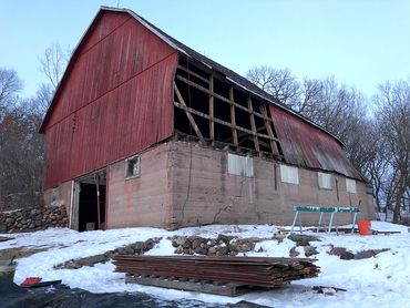 Culled lumber, exterior of deconstruction in progress on a barn rather than demolition.