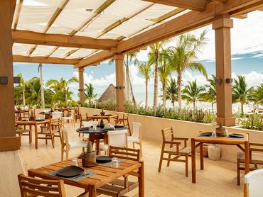 High-end elegant beachside restaurant at Corasol, offering gourmet dining with stunning ocean views