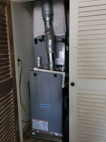 A Comfortmaker HVAC unit installed in a closet space.