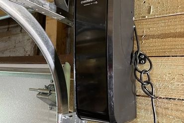Chamberlain garage door opener installed on wooden wall.