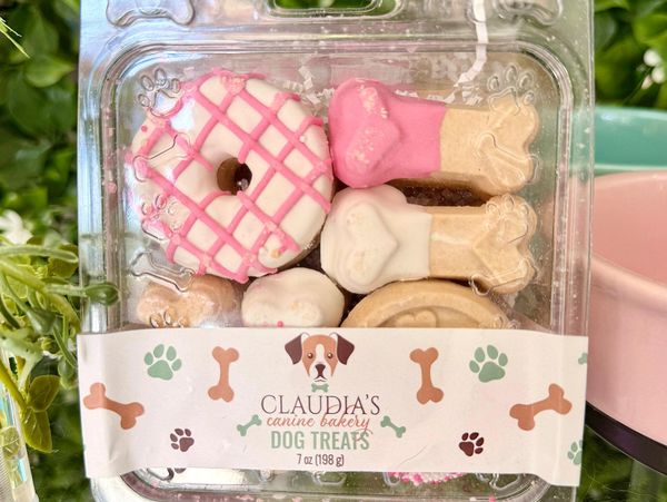 Packaged dog treats shaped like bones and donuts from Claudia's Canine Bakery.