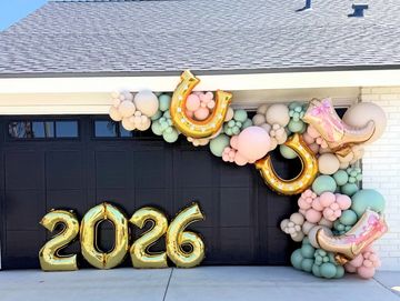 Garage decorated for 2026 celebration with balloons.