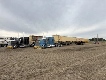 Two trucks hauling overhead crane for construction of a new shop in Fort Macleod Alberta, picked up