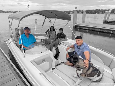 Captain Clearwater private charter boat at the dock in Belleair with guests onboard before a cruise.