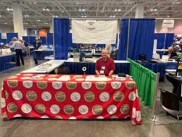 A Nashville Coin Club member volunteers at an outreach booth at the IMEX show in September 2025.