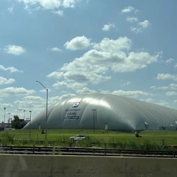 Large silver dome building labeled Parkway Bank Sports Complex.