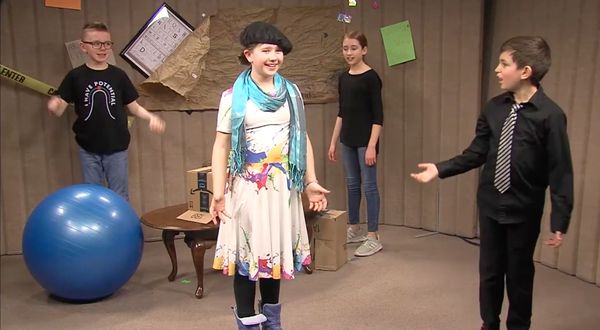 Kids performing their comedy skit project with various objects in frame