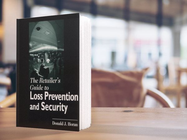 A book on a table reads "The Retailer's Guide to Loss Prevention and Security - Donald J. Horan"
