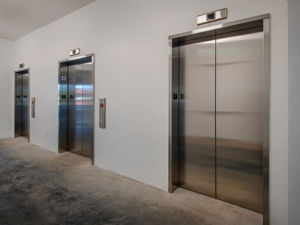 Three modern elevators with stainless steel doors