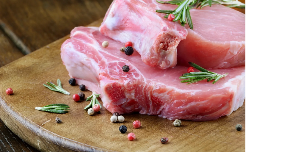 raw pork chops with peppercorns