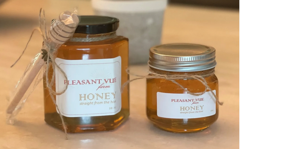 two raw honey jars