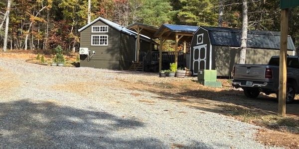 lot 10 phase 2 has a tiny house, decking, carport over RV, & shed