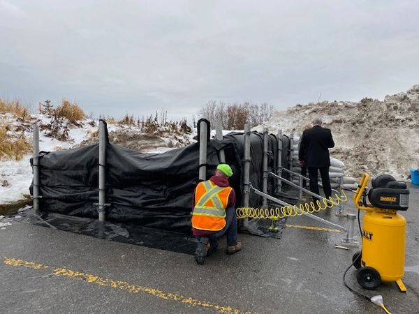 Inflating Flood Defence Systems Barriers with an air compressor.