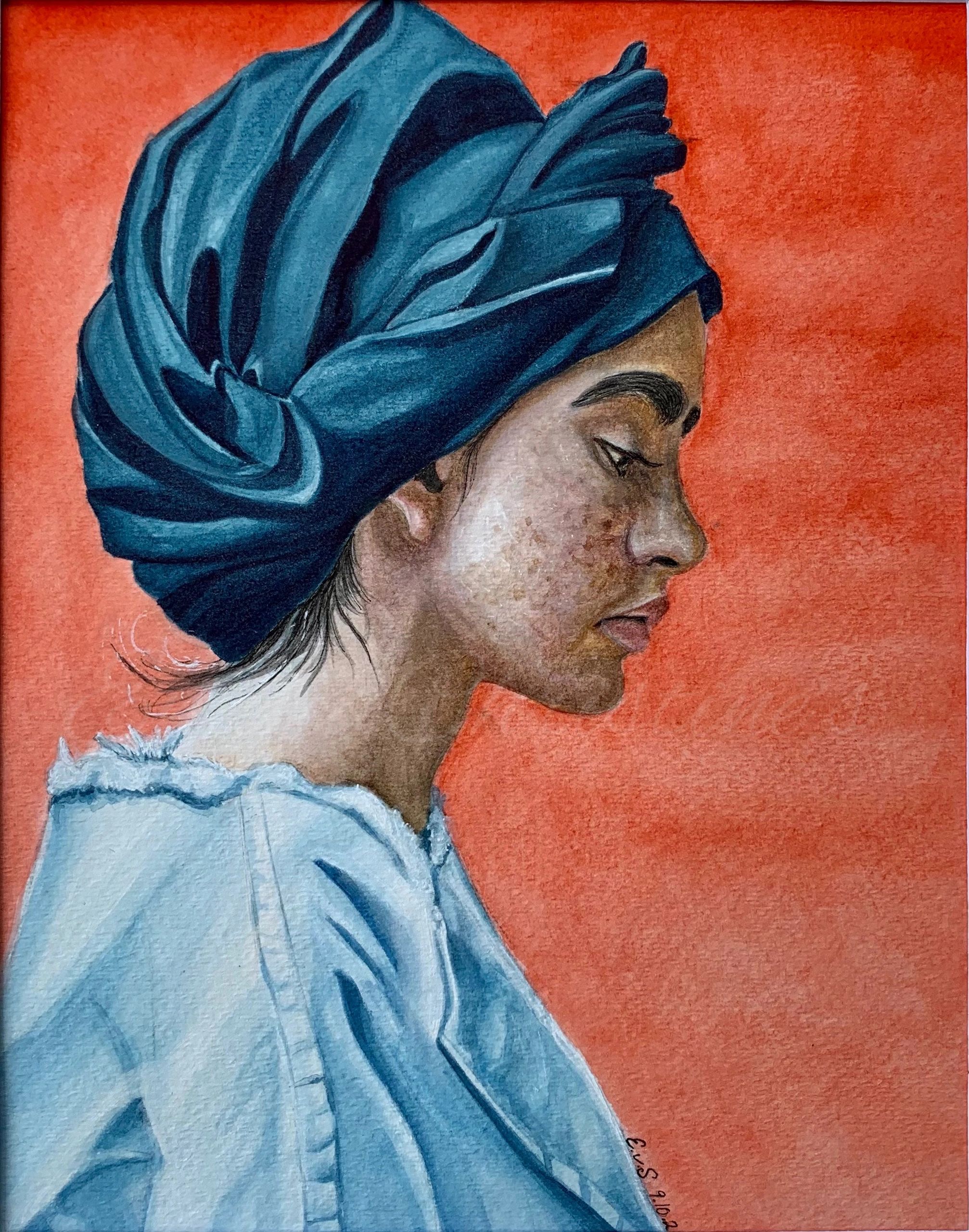 Profile of a woman with freckles in a blue turban with a red background