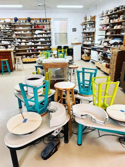 Pottery studio with shelves and worktables.