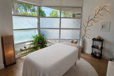 Peaceful massage room with a treatment table and soft lighting.