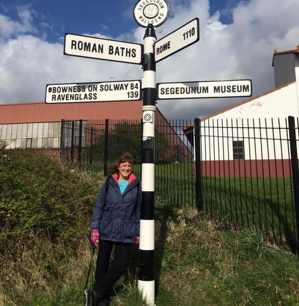 A woman next to a street sign.