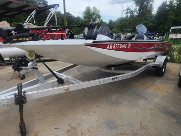 Fishing boat on trailer in driveway.