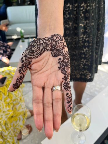 Intricate henna design on palm and fingers.