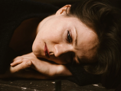 Sadness. Woman lying on floor.