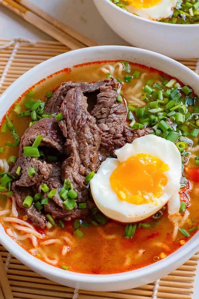 Delicious Ramyeon beef soup with marinated beef and diced spring onions that's spicy wtih sliced egg
