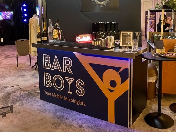 A mobile bar setup called Bar Boys at an indoor event.