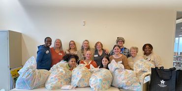 A large group of volunteers at a fundraising activity in 2023