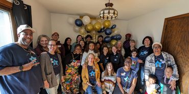 A large group of people at the STAR House Nursery Warming in 2024