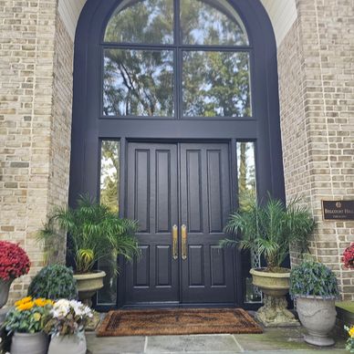 Elegant black double doors with golden handles.