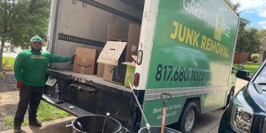 Employee loading cardboard into truck.