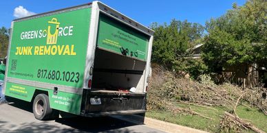 Green Source Junk Removal parked in front of customer house ready to remove yard debris.