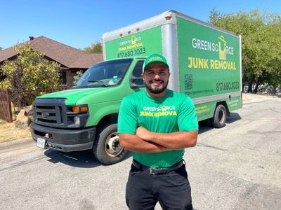 Green Source Junk Removal in front of company truck
