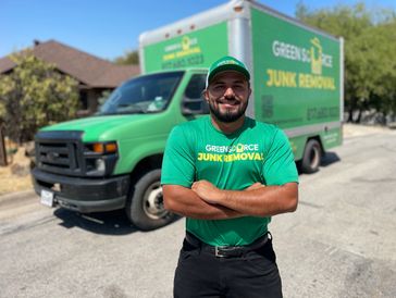 Owner of Green Source Junk Removal standing in front of company truck.