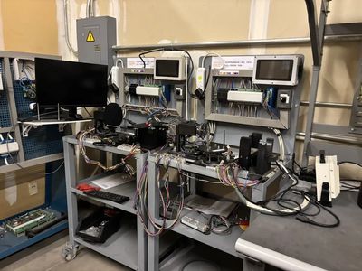 Electronic testing and measurement equipment setup with monitors and wiring.