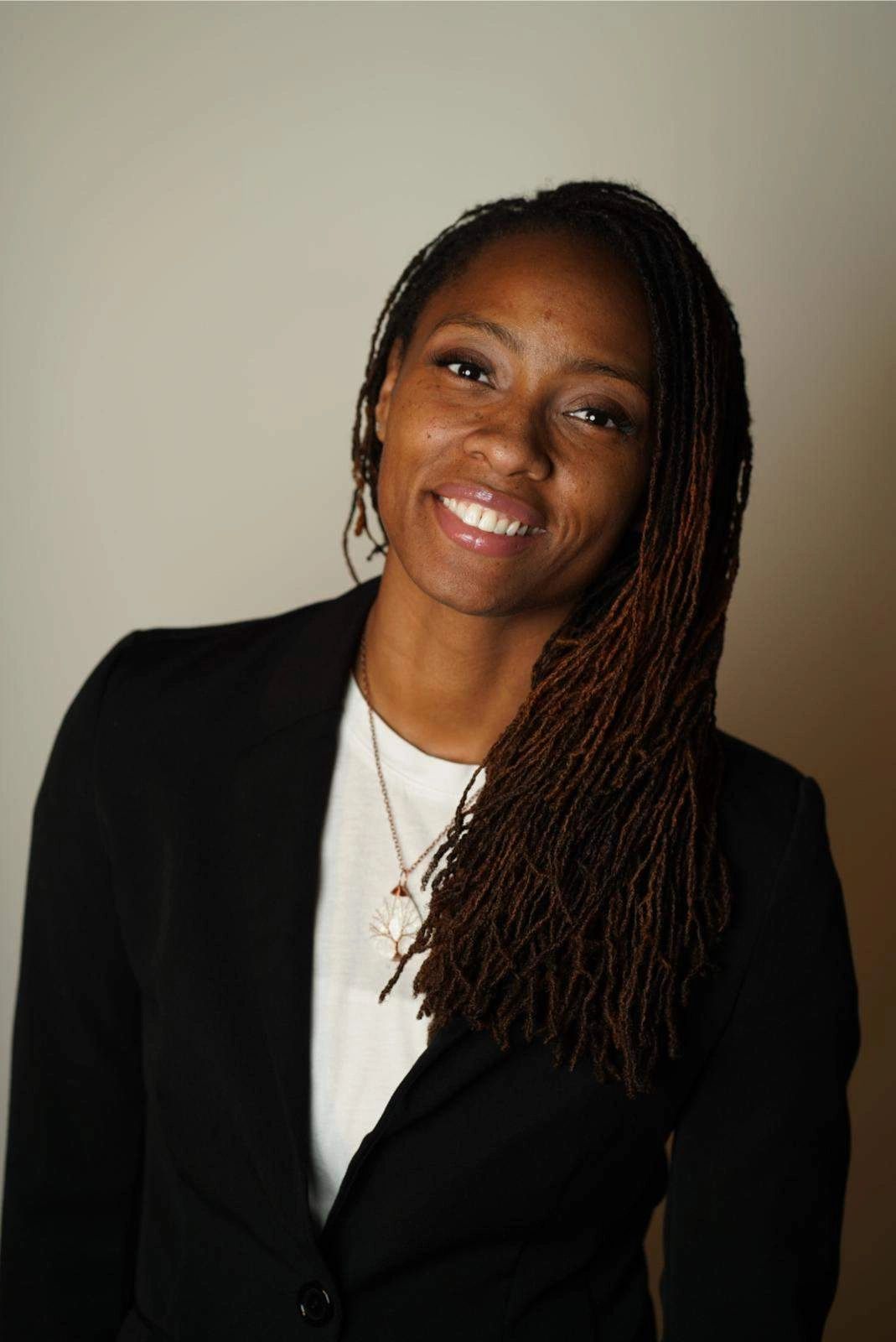 Certified nurse midwife smiling warmly.