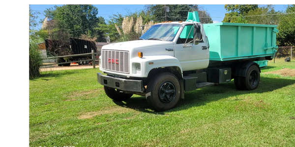 10-yard dumpster on white roll off truck