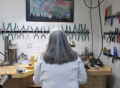 Priscilla Walsen working at the jeweler's bench in her studio.