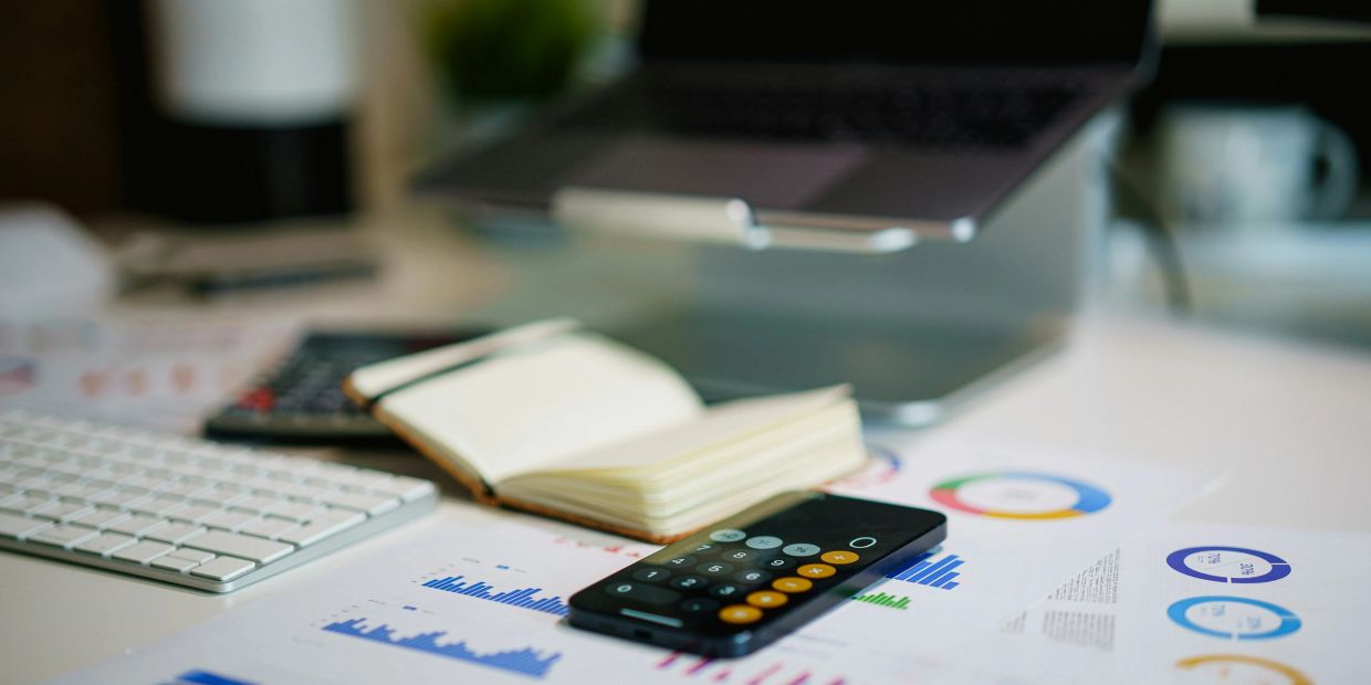 Work desk with calculator and notebook.