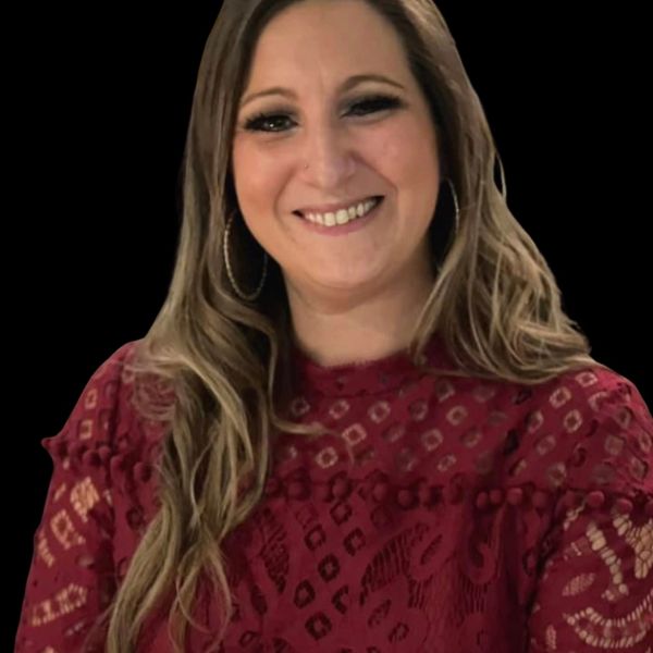 Lena Borrelli in a red patterned lace top against a black background.